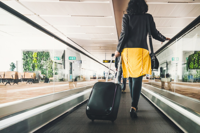 radiotherapy centre - Woman traveller with travel suitcase