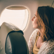 Cancer treatment radiotherapy - Traveler girl watching through airplane window