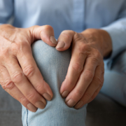 External radiation - Old woman touching knee feeling pain