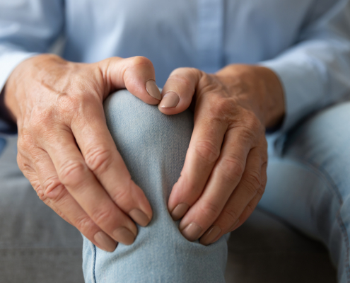 External radiation - Old woman touching knee feeling pain
