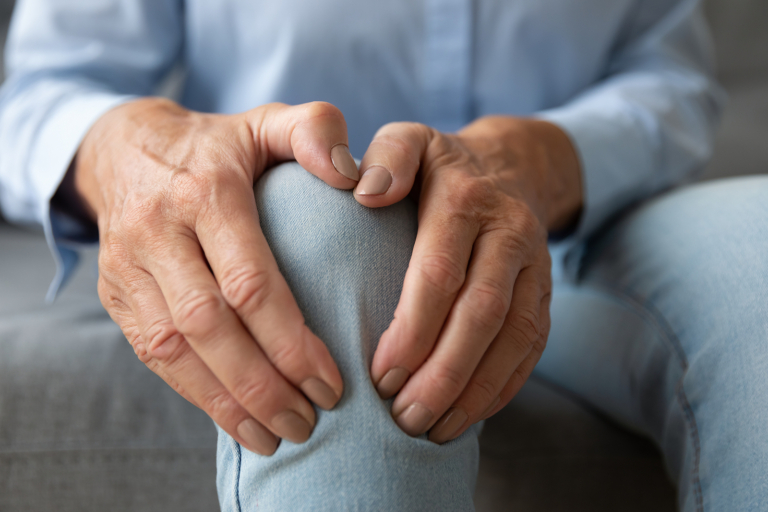 External radiation - Old woman touching knee feeling pain