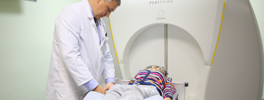 gamma knife radiosurgery - physician prepares patient for the procedure on the Gamma Knife