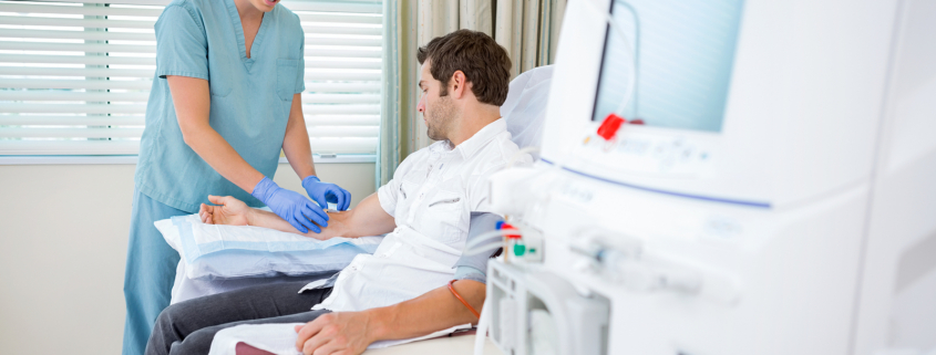 cancer treatment radiotherapy - Mid adult female nurse injecting patient for renal dialysis
